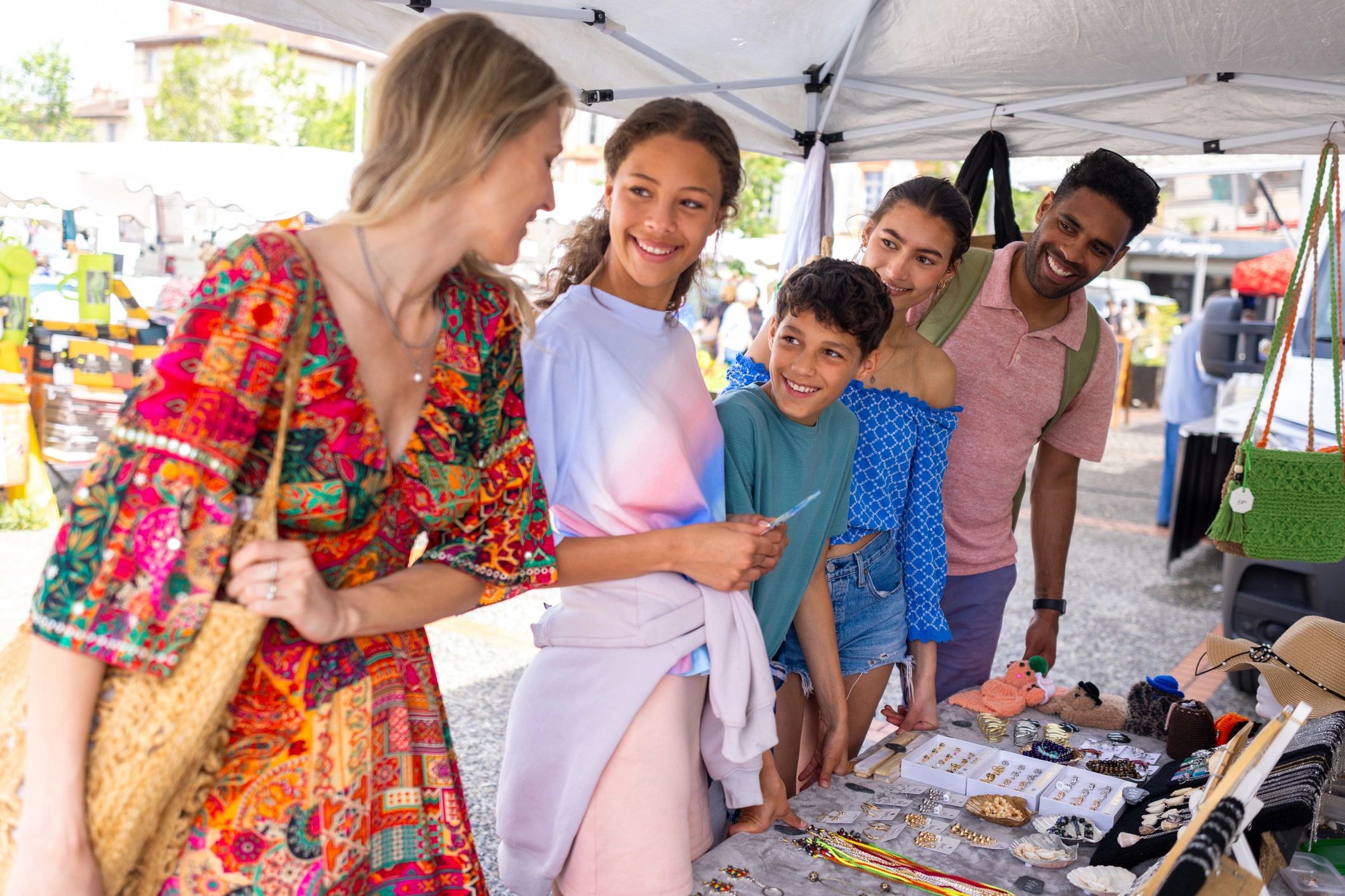 People browsing vendor booths at an outdoor market