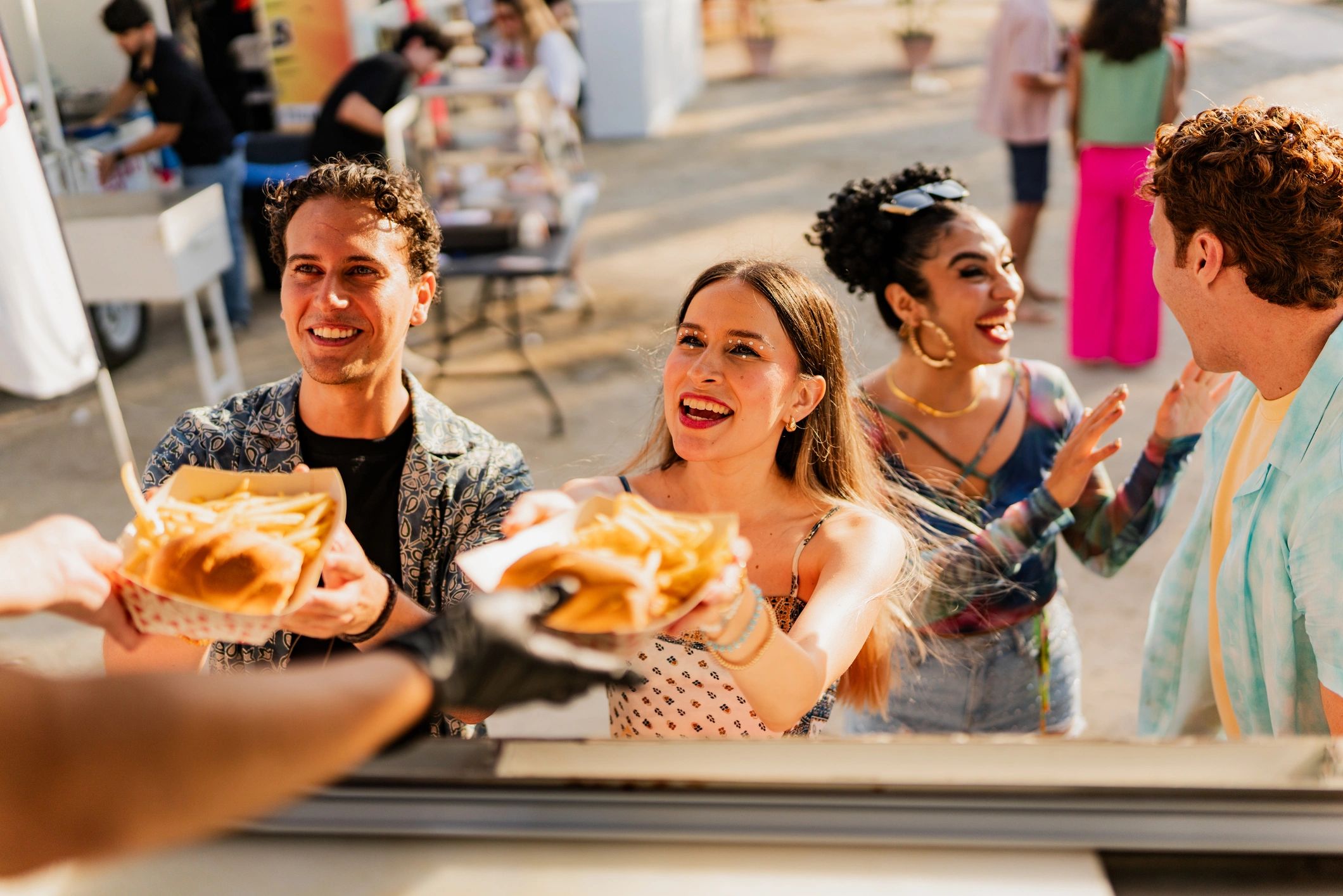 Friends buying snacks outdoors near a food truck