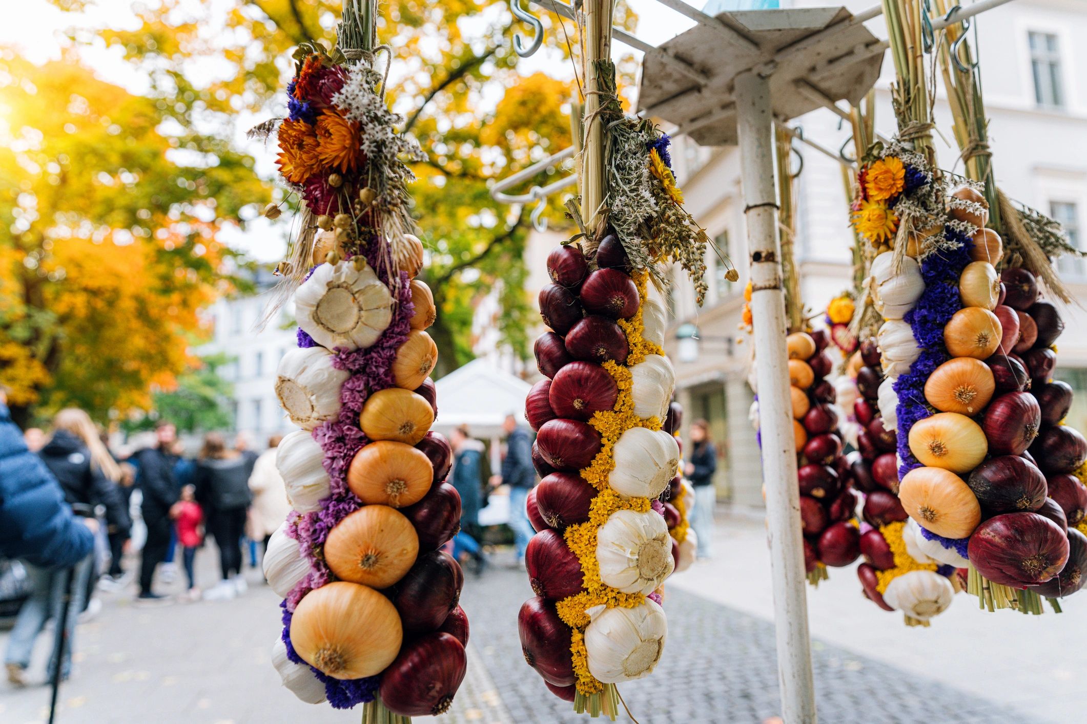Hanging onion braids and flowers at a market festival