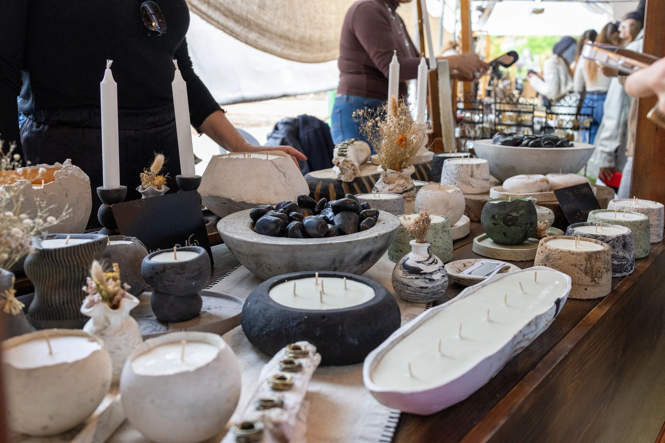 Handmade candles displayed at an artisan market
